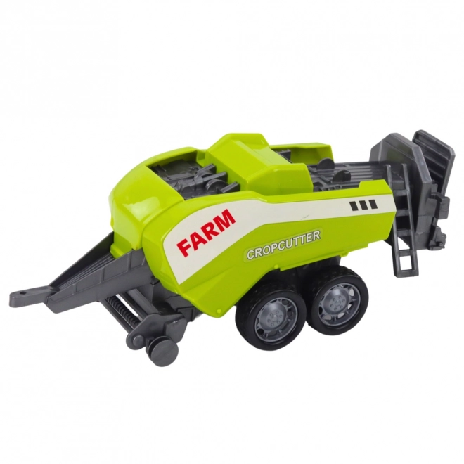 Červený traktor s nakladačem a balíkovačem