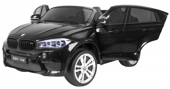 BMW X6M XXL pro 2 děti Černá + Dálkové ovládání + Eko kůže + Bezpečnostní pásy + Pomalý rozjezd + MP3 USB + LED dioda