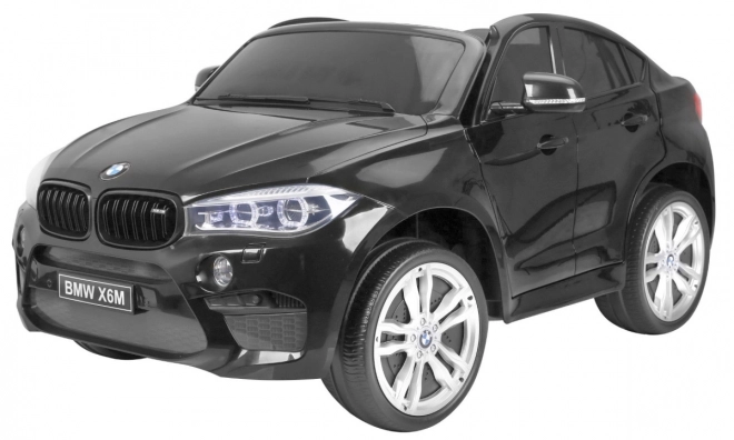 BMW X6M XXL pro 2 děti Černá + Dálkové ovládání + Eko kůže + Bezpečnostní pásy + Pomalý rozjezd + MP3 USB + LED dioda