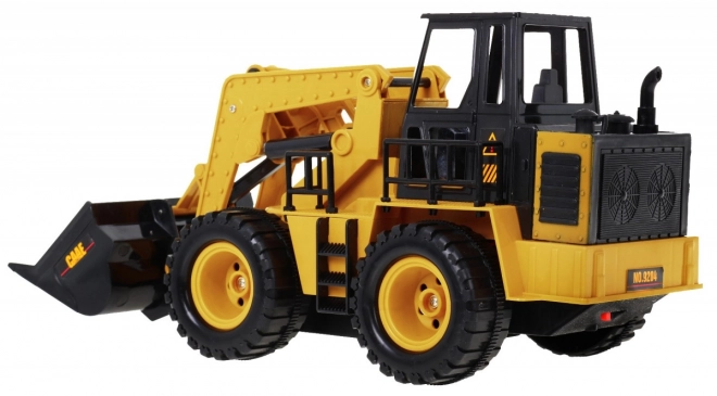 Dálkově ovládaný buldozer pro děti 3+ Model 1:24 Pohyblivý kbelík + zvuky + příslušenství