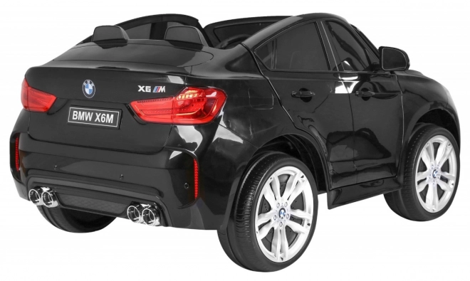 BMW X6M XXL pro 2 děti Černá + Dálkové ovládání + Eko kůže + Bezpečnostní pásy + Pomalý rozjezd + MP3 USB + LED dioda