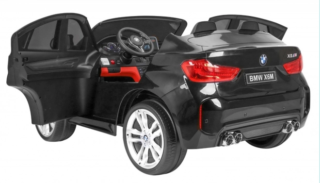 BMW X6M XXL pro 2 děti Černá + Dálkové ovládání + Eko kůže + Bezpečnostní pásy + Pomalý rozjezd + MP3 USB + LED dioda